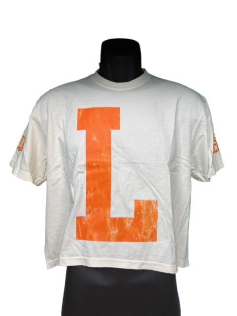 A white short-sleeve crop top t-shirt with a large distressed orange block letter 'L' on the front, displayed on a black mannequin torso against a white background.